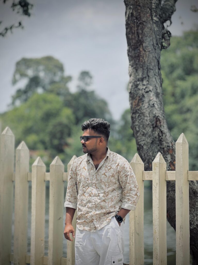 Best Freelance Digital Marketer in MalappuramMan standing near a wooden fence.